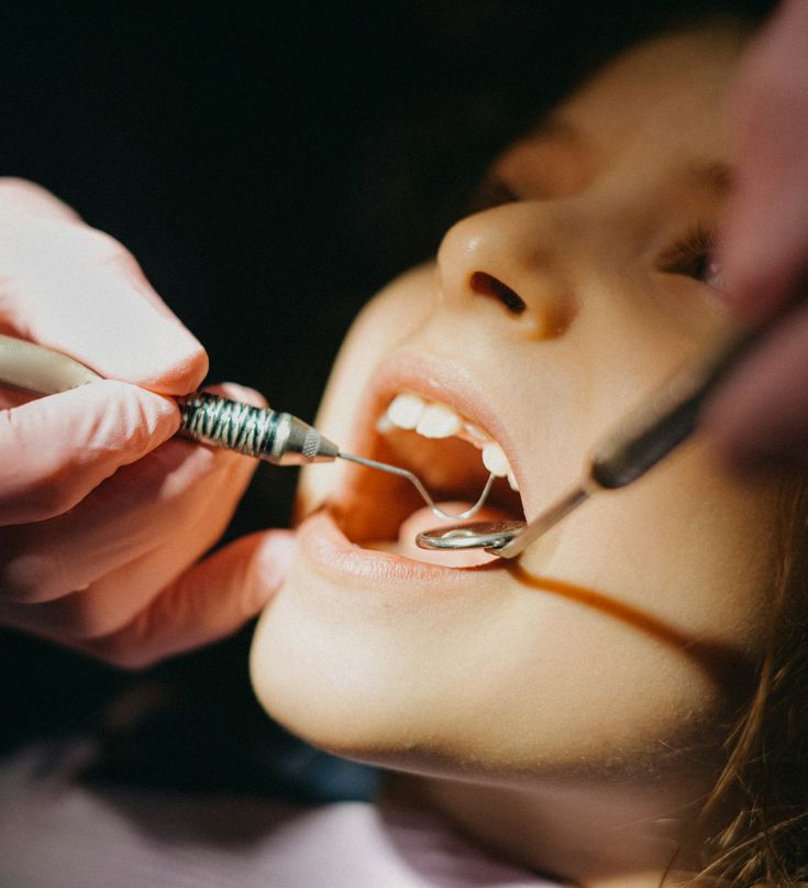 Child receiving dental examination and treatment